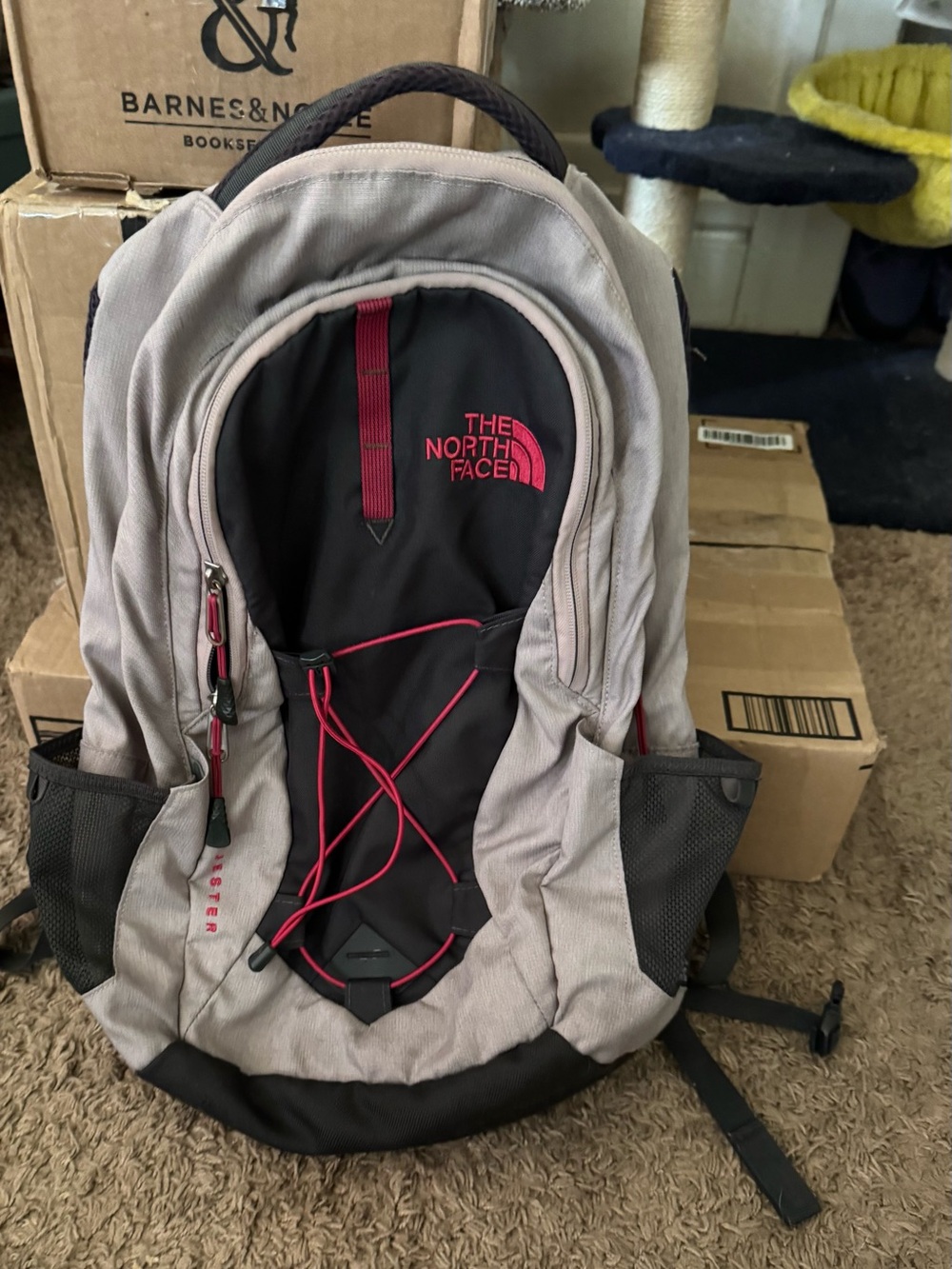 The North Face Gray and Black Backpack with Pink Bungee and Logo